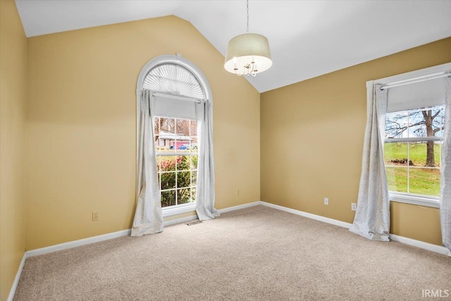 unfurnished room with a wealth of natural light, light carpet, and lofted ceiling