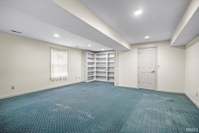 basement featuring carpet floors and a textured ceiling