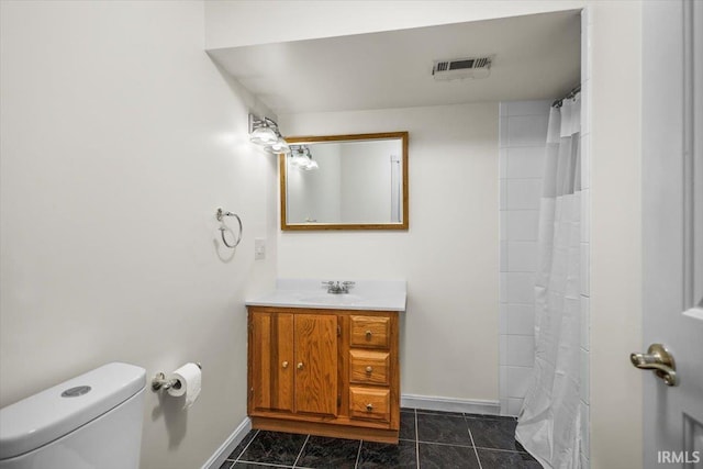 bathroom with tile patterned floors, vanity, and toilet