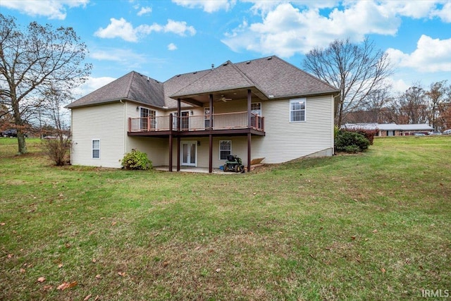 rear view of house featuring a deck, ceiling fan, a patio area, and a lawn