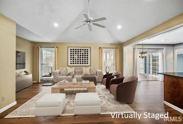 living room with plenty of natural light, dark hardwood / wood-style flooring, and vaulted ceiling