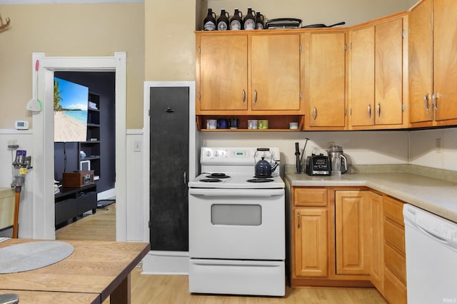 kitchen with white appliances and light hardwood / wood-style floors