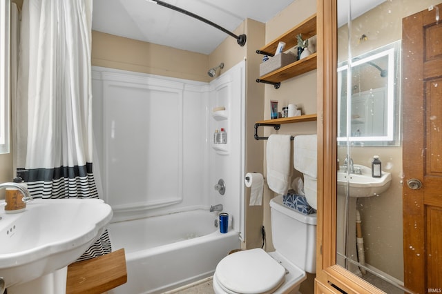 full bathroom with shower / bath combo with shower curtain, sink, and toilet