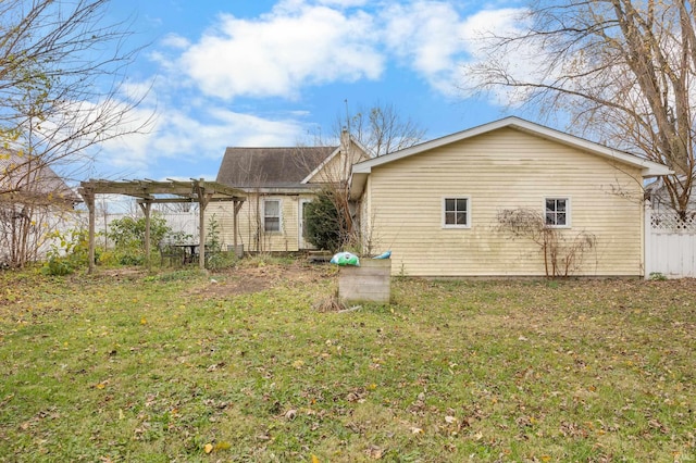 rear view of house with a yard