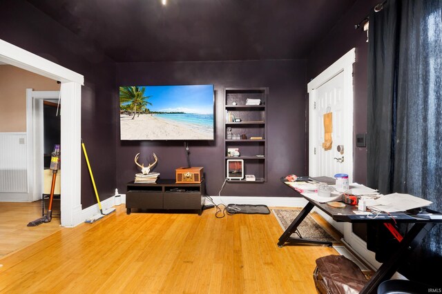 home theater room featuring hardwood / wood-style flooring