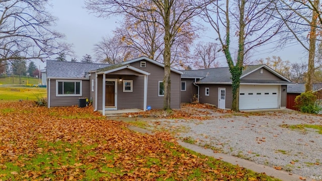 view of front of property with central AC unit and a garage