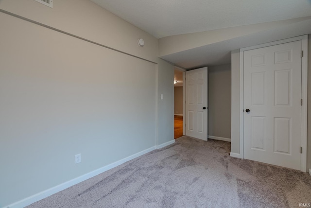 unfurnished bedroom with light carpet