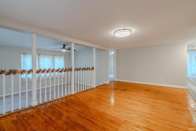 spare room featuring a textured ceiling, hardwood / wood-style flooring, and ceiling fan