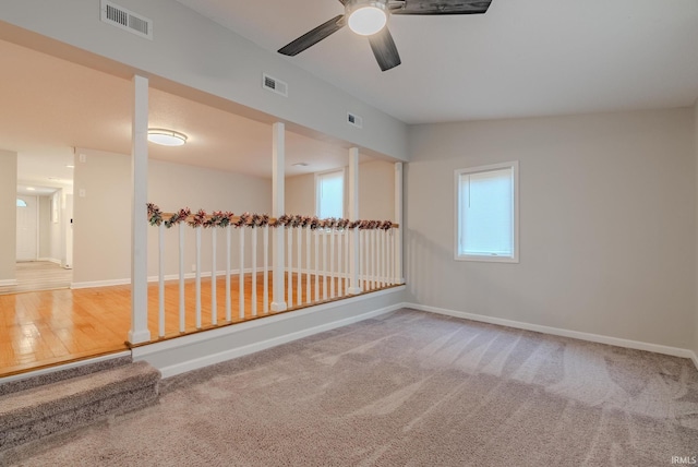 carpeted empty room featuring plenty of natural light, lofted ceiling, and ceiling fan