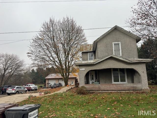 view of side of property with a porch and a yard