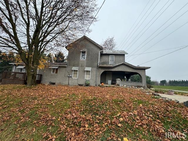 rear view of house featuring a wooden deck