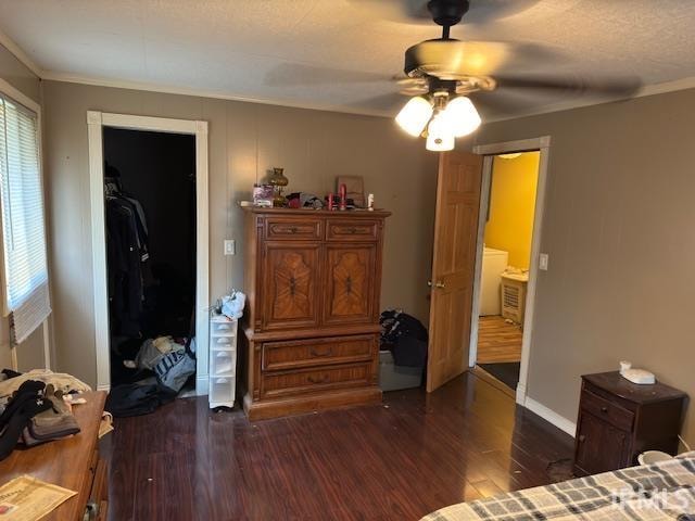 bedroom featuring ceiling fan, a closet, crown molding, and dark hardwood / wood-style floors