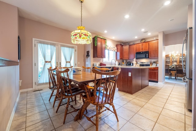 tiled dining space featuring french doors