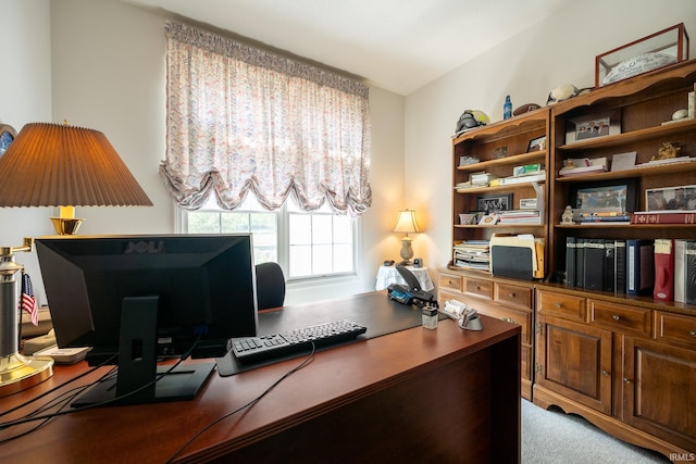 carpeted office space with vaulted ceiling