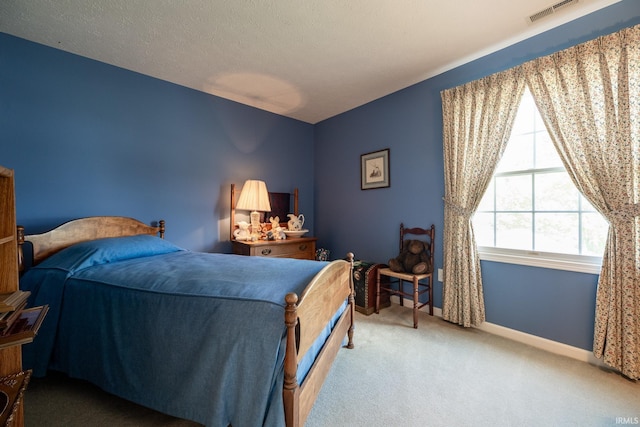 carpeted bedroom with a textured ceiling