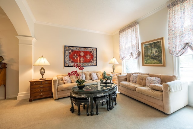 carpeted living room with ornate columns and crown molding