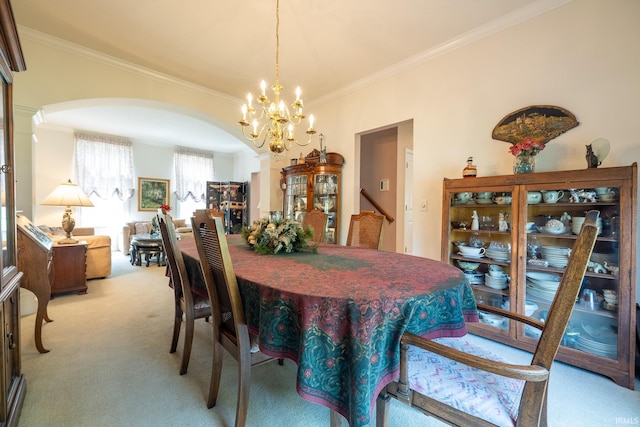 carpeted dining room featuring ornamental molding and an inviting chandelier