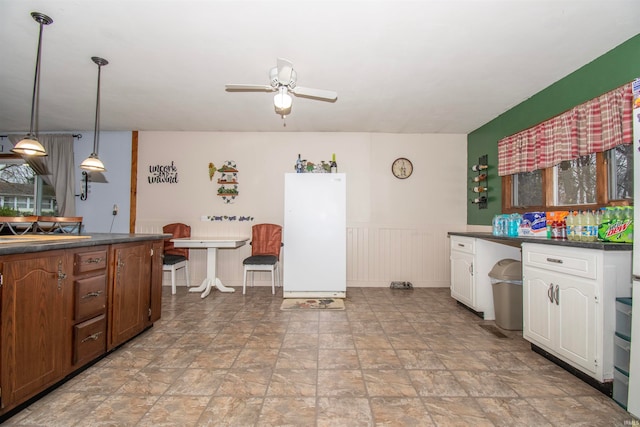 kitchen with white cabinets, ceiling fan, and decorative light fixtures