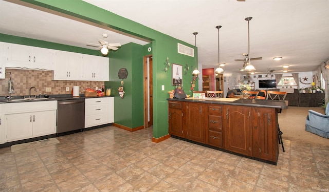 kitchen featuring dishwasher, sink, kitchen peninsula, a breakfast bar area, and decorative backsplash