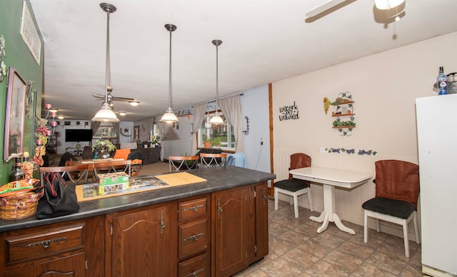 kitchen with pendant lighting, ceiling fan, and white refrigerator