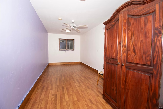 empty room featuring light wood-type flooring and ceiling fan