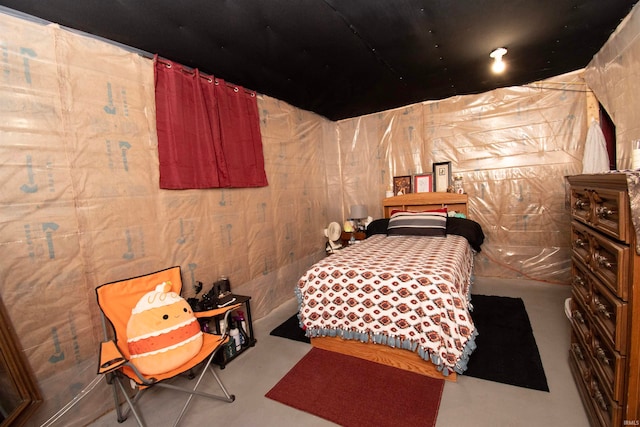 bedroom featuring concrete flooring