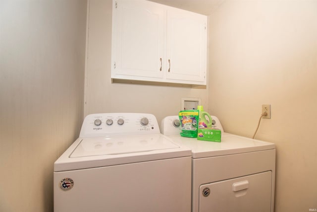 washroom with cabinets and separate washer and dryer