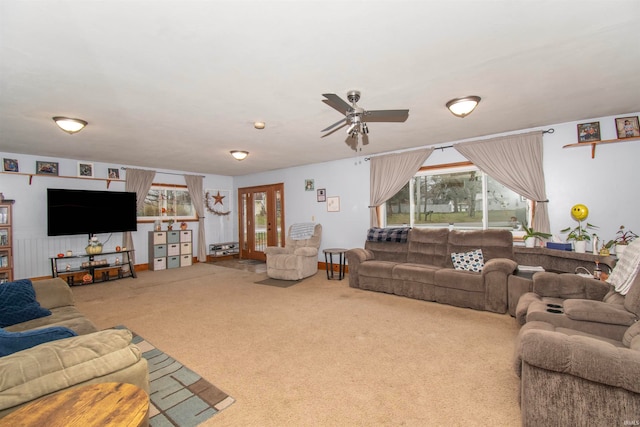 carpeted living room featuring ceiling fan