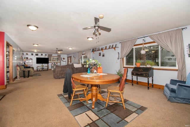 carpeted dining space featuring ceiling fan