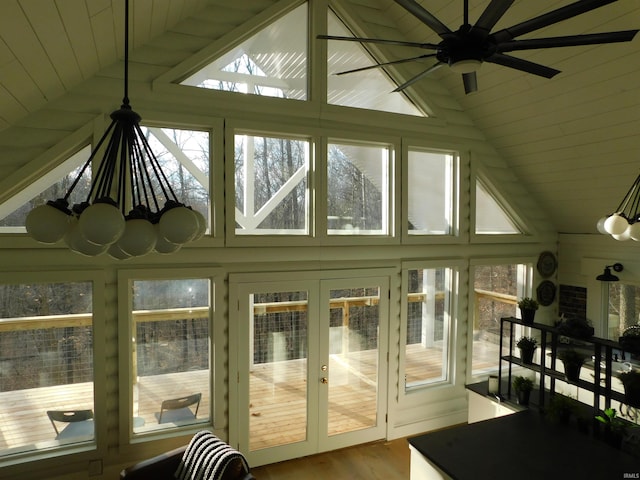 sunroom featuring a healthy amount of sunlight and vaulted ceiling