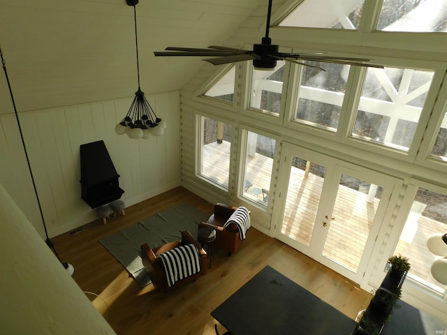 living room featuring ceiling fan, hardwood / wood-style floors, a healthy amount of sunlight, and vaulted ceiling