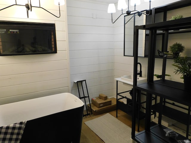 bathroom featuring wooden walls and wood-type flooring