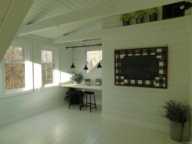 sunroom featuring wood ceiling and lofted ceiling with beams