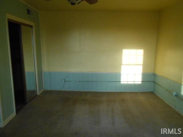 empty room with carpet flooring and ceiling fan