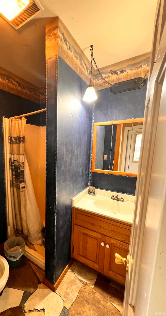 full bathroom featuring visible vents, a shower stall, and vanity