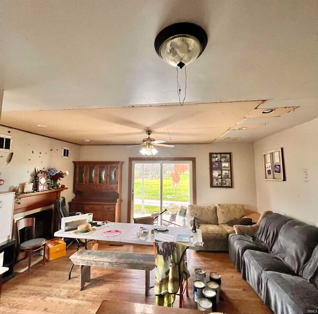 living area featuring ceiling fan, wood finished floors, and visible vents