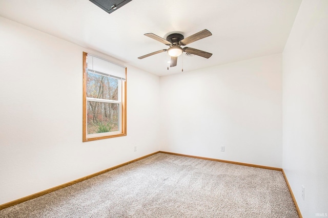 spare room with baseboards, ceiling fan, and carpet flooring