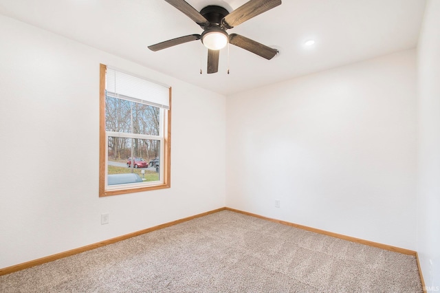 unfurnished room featuring ceiling fan, baseboards, and carpet