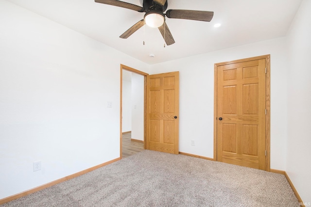 unfurnished bedroom with carpet flooring, baseboards, and ceiling fan