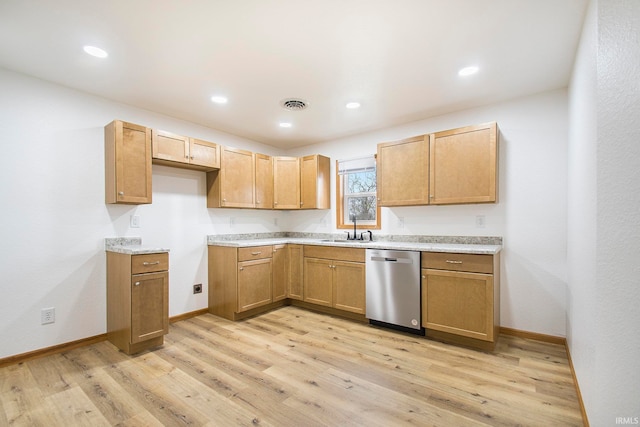 kitchen with visible vents, baseboards, dishwasher, light wood-style flooring, and a sink