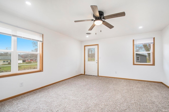 spare room featuring recessed lighting, visible vents, light colored carpet, and baseboards