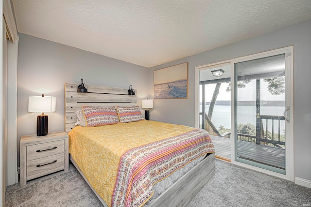 bedroom with access to exterior, light colored carpet, and a textured ceiling