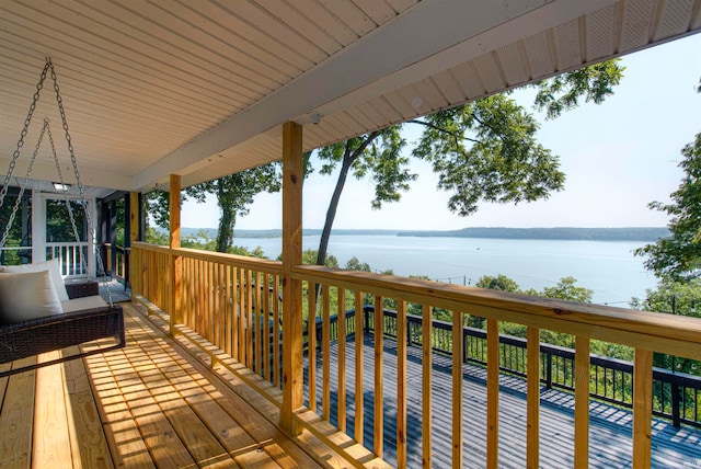 wooden terrace featuring a water view