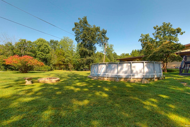 view of yard with a fire pit