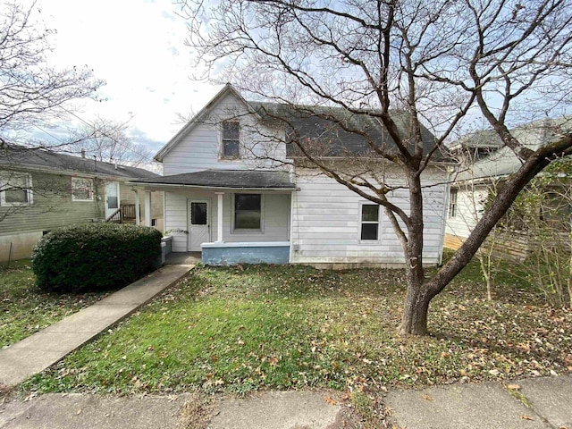 view of front of house with a porch and a front yard