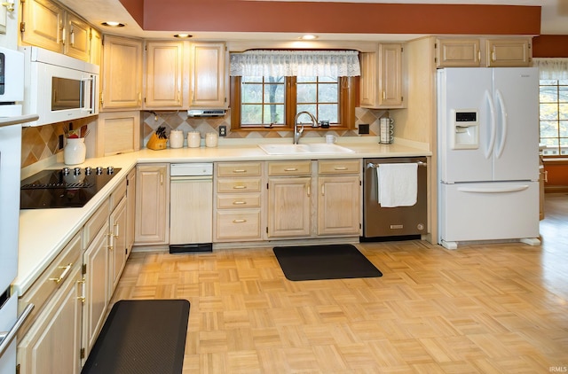 kitchen with decorative backsplash, sink, light parquet flooring, and white appliances