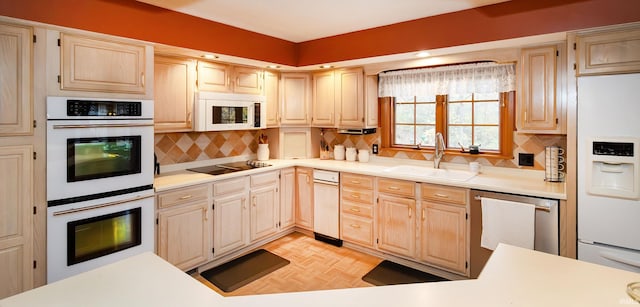 kitchen featuring white appliances, tasteful backsplash, light parquet flooring, and sink