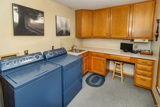 clothes washing area with cabinets, sink, a textured ceiling, carpet floors, and washing machine and clothes dryer