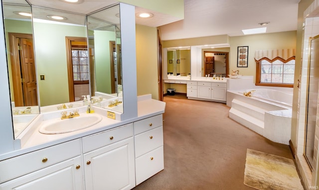 bathroom with vanity and tiled bath