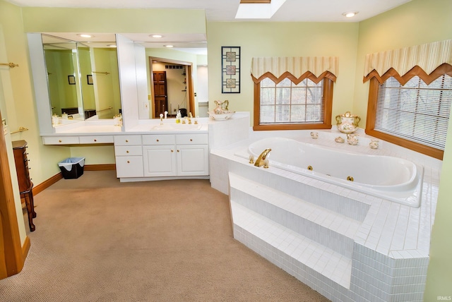 bathroom featuring vanity and a relaxing tiled tub